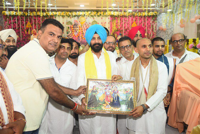 Prasadam distribution with traditional Indian vegetarian food offerings