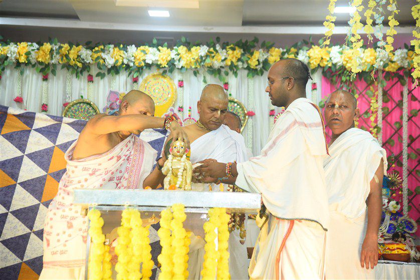 Beautiful altar of Lord Krishna with fresh flowers and decorations